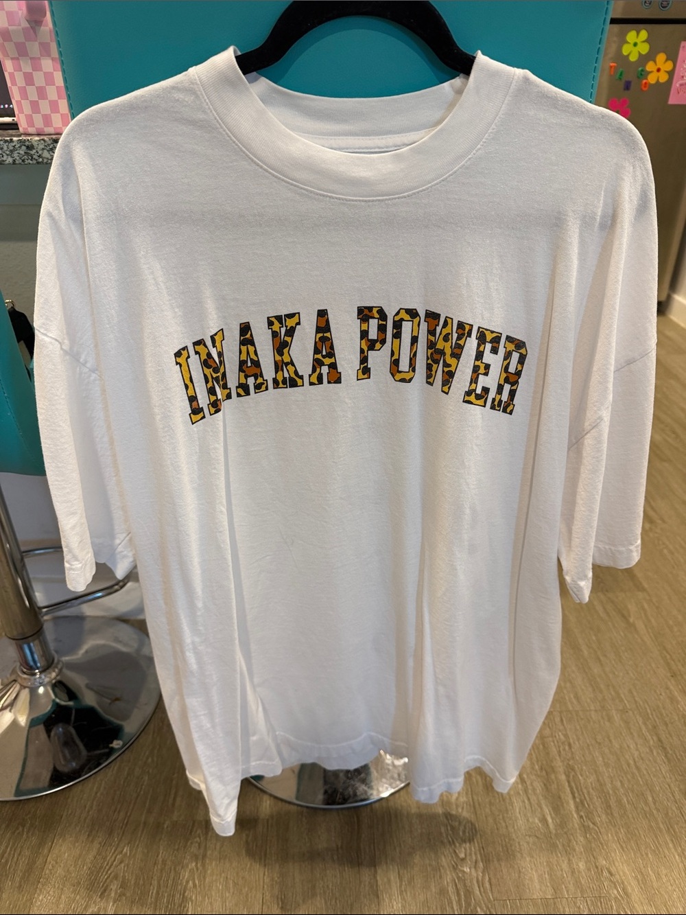 Inaka Power White Tee with Yellow-Brown Patterned Lettering